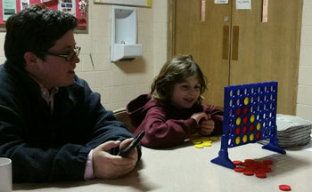 Playing a game during Eden Open while Pastor Jacki watches.