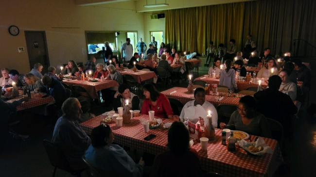 Diners sitting at candle-lit tables.